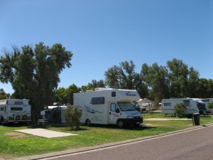 Shady grassed caravan and camping sites at Arno Bay Caravan Park.